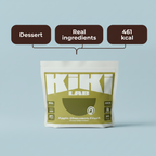 A stand-up pouch of Kiki Lab Apple Cinnamon Crust dessert, shown against a light gray background with three dark brown callout bubbles above reading 'Dessert', 'Real ingredients', and '461 kcal'.